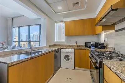 a kitchen with a sink and a dishwasher at Apartment with Burj Khalifa View I Bellevue Tower in Dubai