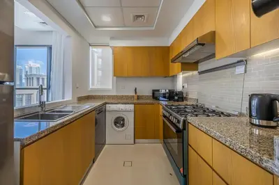a kitchen with a washer and dryer at Apartment with Burj Khalifa View I Bellevue Tower in Dubai