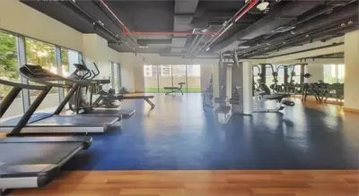 a gym with treadmills and exercise machines in it at Apartment with Burj Khalifa View I Bellevue Tower in Dubai