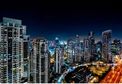a night view of a large city with many tall buildings at Paramount Downtown Burj Khalifa View with 64th floor Infinity pool in Dubai