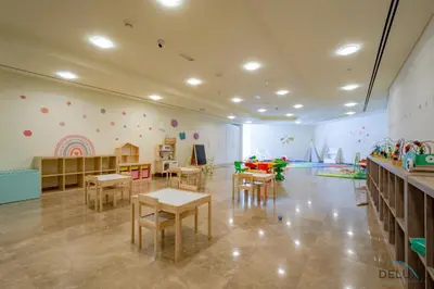a room with tables and chairs and a play area at Jubilant Studio at Sky Gardens, DIFC by Deluxe Holiday Homes in Dubai