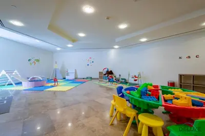 a play room with a table and chairs at Jubilant Studio at Sky Gardens, DIFC by Deluxe Holiday Homes in Dubai