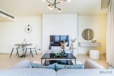 a living room with a couch and a table at Jubilant Studio at Sky Gardens, DIFC by Deluxe Holiday Homes in Dubai