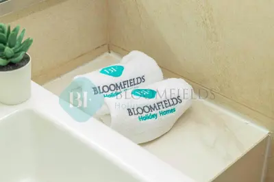 a pair of towels sitting on top of a bathroom counter at Bloomfields Cozy Stu Azizi Riviera Meydan in Dubai