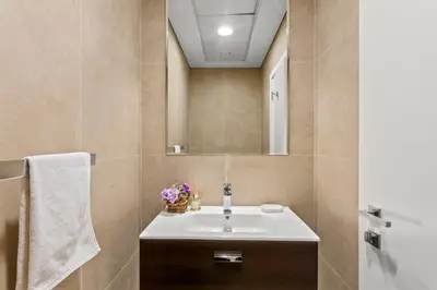 a bathroom with a sink and a mirror at GuestReady - Luxury haven at Marina Arcade in Dubai