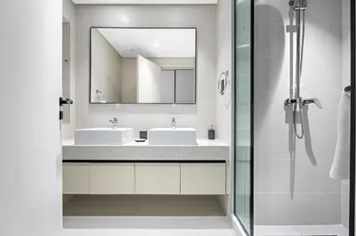 a bathroom with two sinks and a mirror at Family Friendly 2BDR With Sea & City View in Dubai