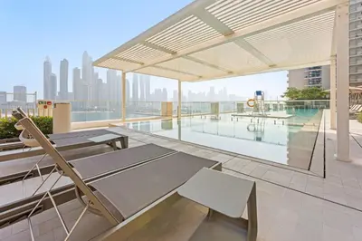 an outdoor patio with a pool on a building at Family Friendly 2BDR With Sea & City View in Dubai