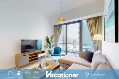 a living room with a couch and a television at Silverene Tower B - Bright Two Bedroom in Dubai