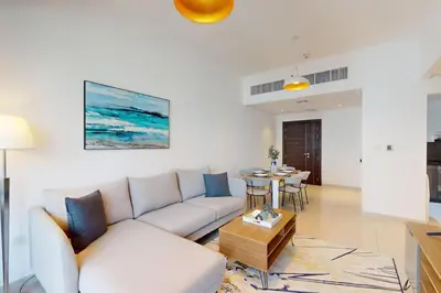 a living room with a couch and a table at Silverene Tower B - Bright Two Bedroom in Dubai