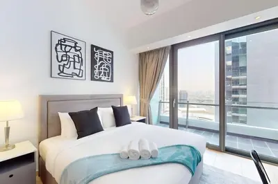a bedroom with a bed with two white shoes on it at Silverene Tower B - Bright Two Bedroom in Dubai