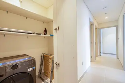 a washing machine in a laundry room with a hallway at Luxury 4BR Burj Khalifa & Fountain Views in Dubai