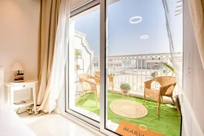 a room with a large glass door to a balcony at Studio Apartment in Vincitore Palacio Arjan in Dubai