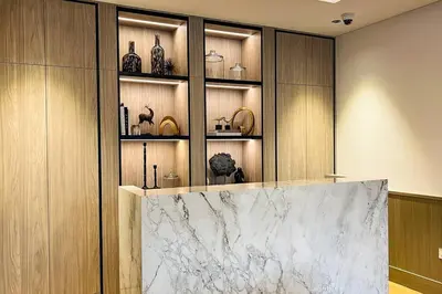 a room with a counter with vases on shelves at Brand New 1 Bedroom Apartment JVC in Dubai