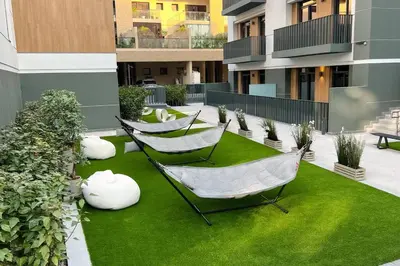 two hammocks on a lawn in a building at Brand New 1 Bedroom Apartment JVC in Dubai