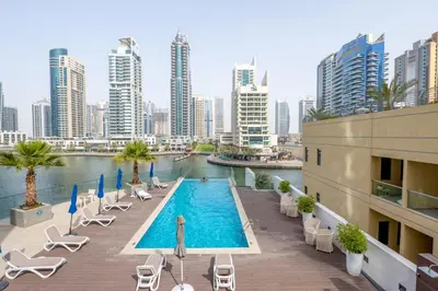 a swimming pool on top of a building with a city at Luxury Living in Marina Liv Residence 2BR in Dubai