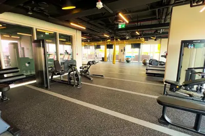 a gym with treadmills and chairs in a room at Brand New Apartment in Socio Tower Dubai Hills in Dubai