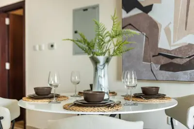 a dining room table with glasses and a vase at GuestReady - Luxury haven in JLT in Dubai