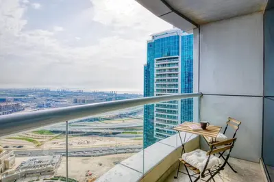 a balcony with a desk and a view of a city at GuestReady - Luxury haven in JLT in Dubai