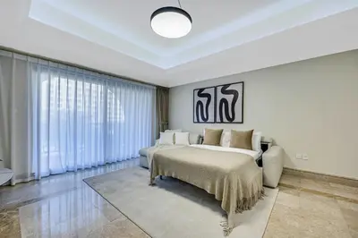 a white bedroom with a bed and a couch at Spacious 1BD apartment in the Residence North in Dubai