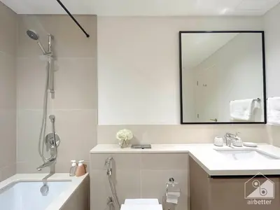 a bathroom with a tub and a sink and a mirror at Luxury Burj Crown 4bedroom Balcony & Downtown View in Dubai