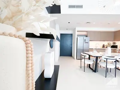 a kitchen and dining room with a table and chairs at Luxury Burj Crown 4bedroom Balcony & Downtown View in Dubai