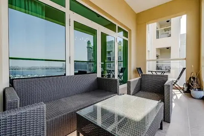 a living room with a couch and a table at Al Hatimi, Shoreline Apartments, Palm Jumeirah, Dubai in Dubai