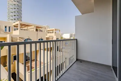 a balcony with a view of a building at Modern and Cozy Studio in JVC I Luma Building in Dubai