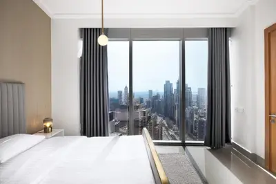 a bedroom with a large bed and a large window at Opera Grand by Emaar LUXURY 1 BR Apartment in Downtown Dubai sea and city view in Dubai