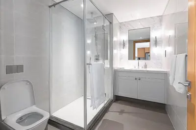 a bathroom with a shower and a toilet and a sink at Opera Grand by Emaar LUXURY 1 BR Apartment in Downtown Dubai sea and city view in Dubai