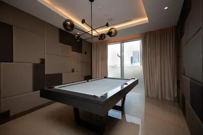 a pool table in a room with a large window at Opera Grand by Emaar LUXURY 1 BR Apartment in Downtown Dubai sea and city view in Dubai