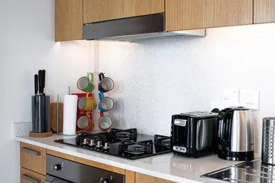 a kitchen counter with a stove and a microwave at Opera Grand by Emaar LUXURY 1 BR Apartment in Downtown Dubai sea and city view in Dubai