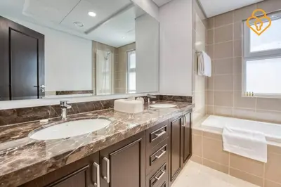 a bathroom with two sinks and a tub and a large mirror at Keysplease Beautiful 3 B/R Villa With Garden, Serena in Dubai