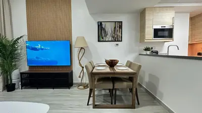 a living room with a table and a television at Modern 1BR Apartment in Dubai Marina with sea view in Dubai