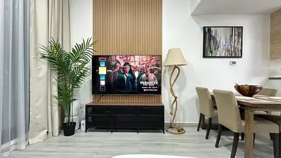a living room with a tv and a table at Modern 1BR Apartment in Dubai Marina with sea view in Dubai