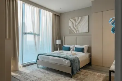 a bedroom with a bed and a large window at Clever Guest 021 Condor Marina Star in Dubai