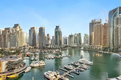 a harbor with boats in a city with tall buildings at Marina Gate - Stunning 56 Floor Full Sea Views in Dubai
