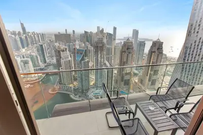 a balcony with chairs and a view of a city at Marina Gate - Stunning 56 Floor Full Sea Views in Dubai