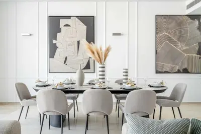 a dining room with a table and chairs at Oceana Luxury 4 BR Apartment with Resort Access and Sea Views by Exclusive Holiday Homes in Dubai