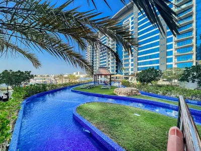 a resort pool with a gazebo in front of a building at Oceana Luxury 4 BR Apartment with Resort Access and Sea Views by Exclusive Holiday Homes in Dubai