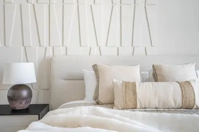 a white bedroom with a bed with white sheets and pillows at Oceana Luxury 4 BR Apartment with Resort Access and Sea Views by Exclusive Holiday Homes in Dubai