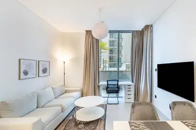 a living room with a couch and a table at Sobha Creek Vistas Cozy 1BDR with balcony in Dubai