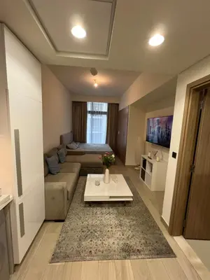 a living room with a couch and a table at Luxury Studio Brand New with HighEnd Furnishings in Dubai