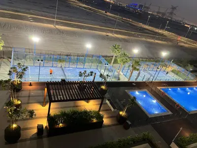 a view of a tennis court at night at Luxury Studio Brand New with HighEnd Furnishings in Dubai