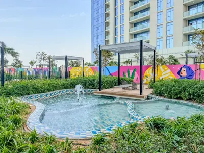 a small pool with a fountain in a park at 35th Floor Luxury 2 BR with Stunning Views in Dubai