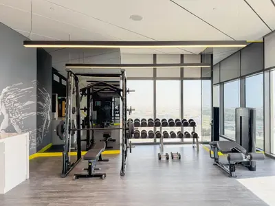 a gym with rows of exercise equipment and windows at 35th Floor Luxury 2 BR with Stunning Views in Dubai