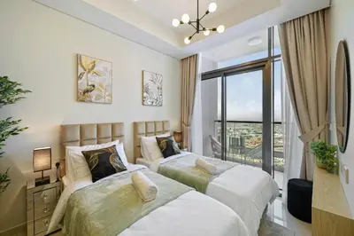 a bedroom with two beds and a large window at 35th Floor Luxury 2 BR with Stunning Views in Dubai
