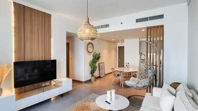 a living room with a couch and a tv at Chic New 2BR Dubai Creek Gate by Tanami Holiday Homes in Dubai