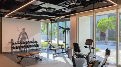 a gym with several treadmills and machines in a room at Chic New 2BR Dubai Creek Gate by Tanami Holiday Homes in Dubai