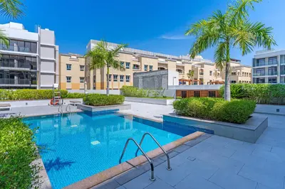 a swimming pool in the middle of a building at Elegant Studio Stay I Pool, Gym & Parking in Dubai