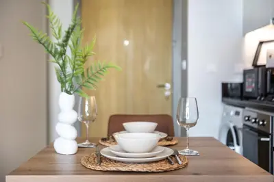 a table with two wine glasses and a bowl on it at GuestReady - Contemporary studio in Business Bay in Dubai